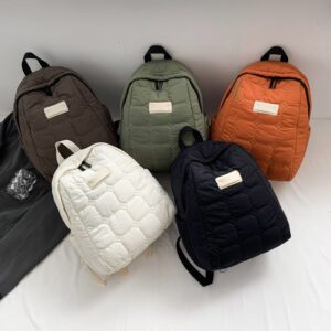 A flat-lay showcase of our Korean-style quilted puffer backpacks (PETITE) in a range of trendy earth tones. These lightweight, stylish bags feature a unique hexagonal stitch pattern and a soft, pillowy texture for a modern office look.
