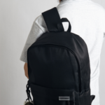 This hip, minimalistic Japanese backpack blends effortlessly with any casual outfit. Perfect for everyday wear, it features dedicated compartments for your laptop, iPad, and phone, keeping your essentials organized. An anti-theft back pocket provides extra security for your wallet and personal items. Style it with our adorable frog bag charm for a playful fashion upgrade.