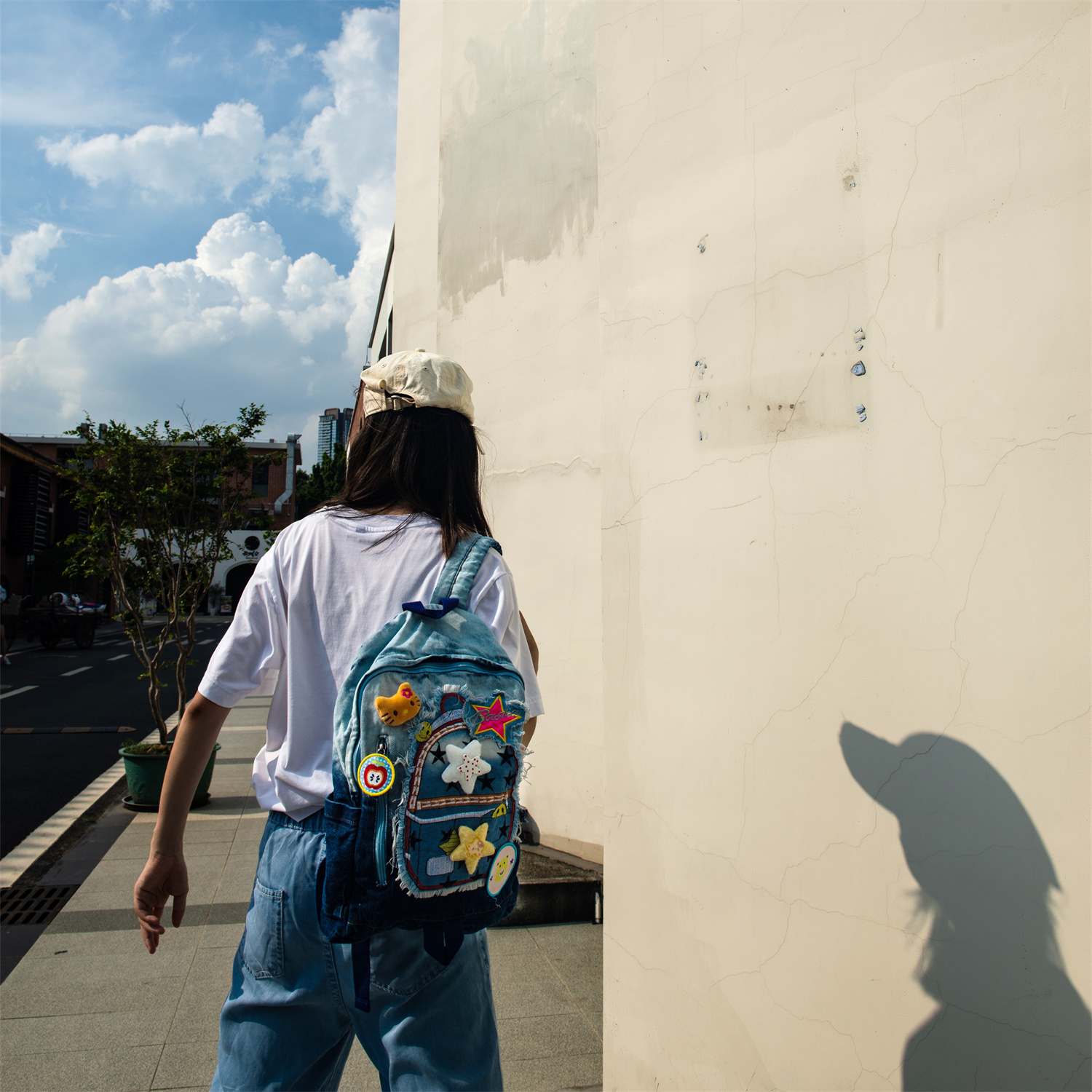 JINZU is a stylish medium-sized denim backpack adorned with playful, colorful pins—perfect for adding whimsy to your look. Lightweight and well-compartmentalized, it keeps your essentials organized whether you're heading to class or a casual party.