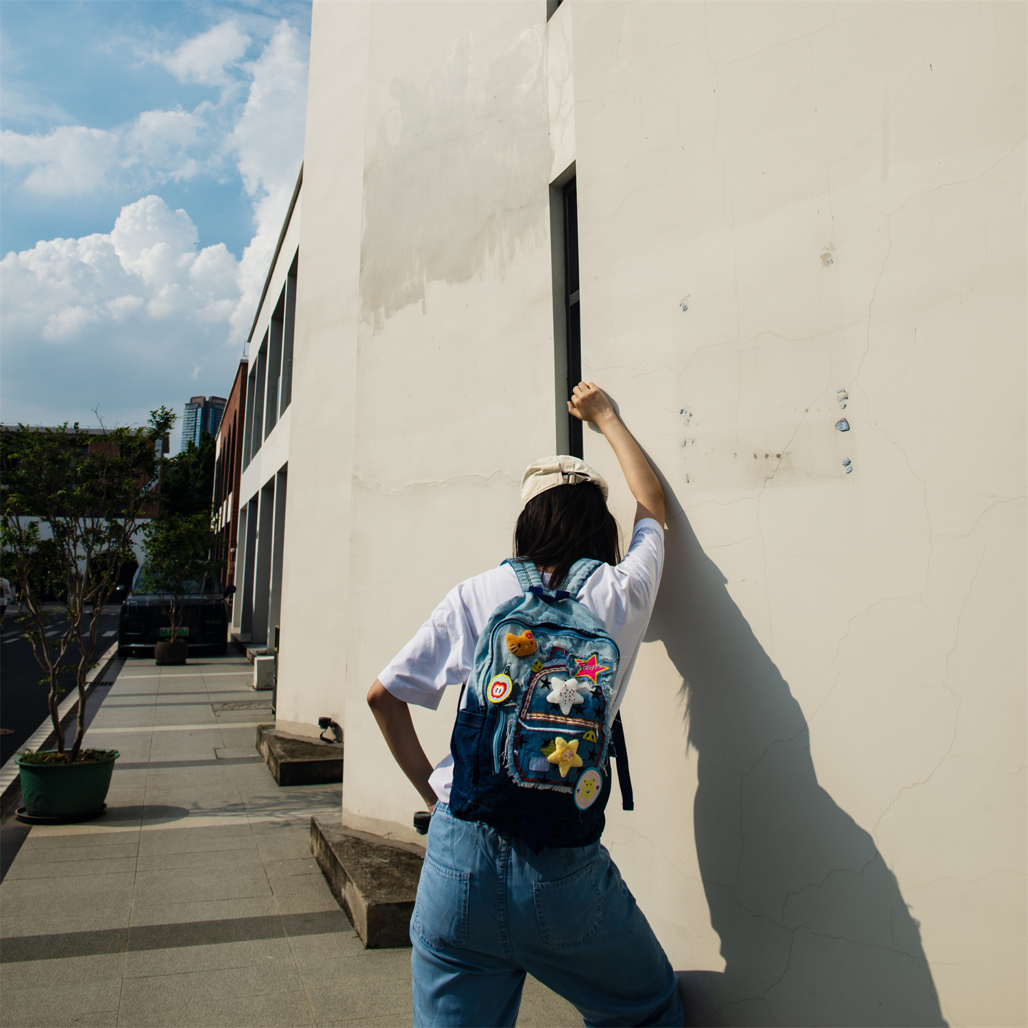 JINZU is a stylish medium-sized denim backpack adorned with playful, colorful pins—perfect for adding whimsy to your look. Lightweight and well-compartmentalized, it keeps your essentials organized whether you're heading to class or a casual party.
