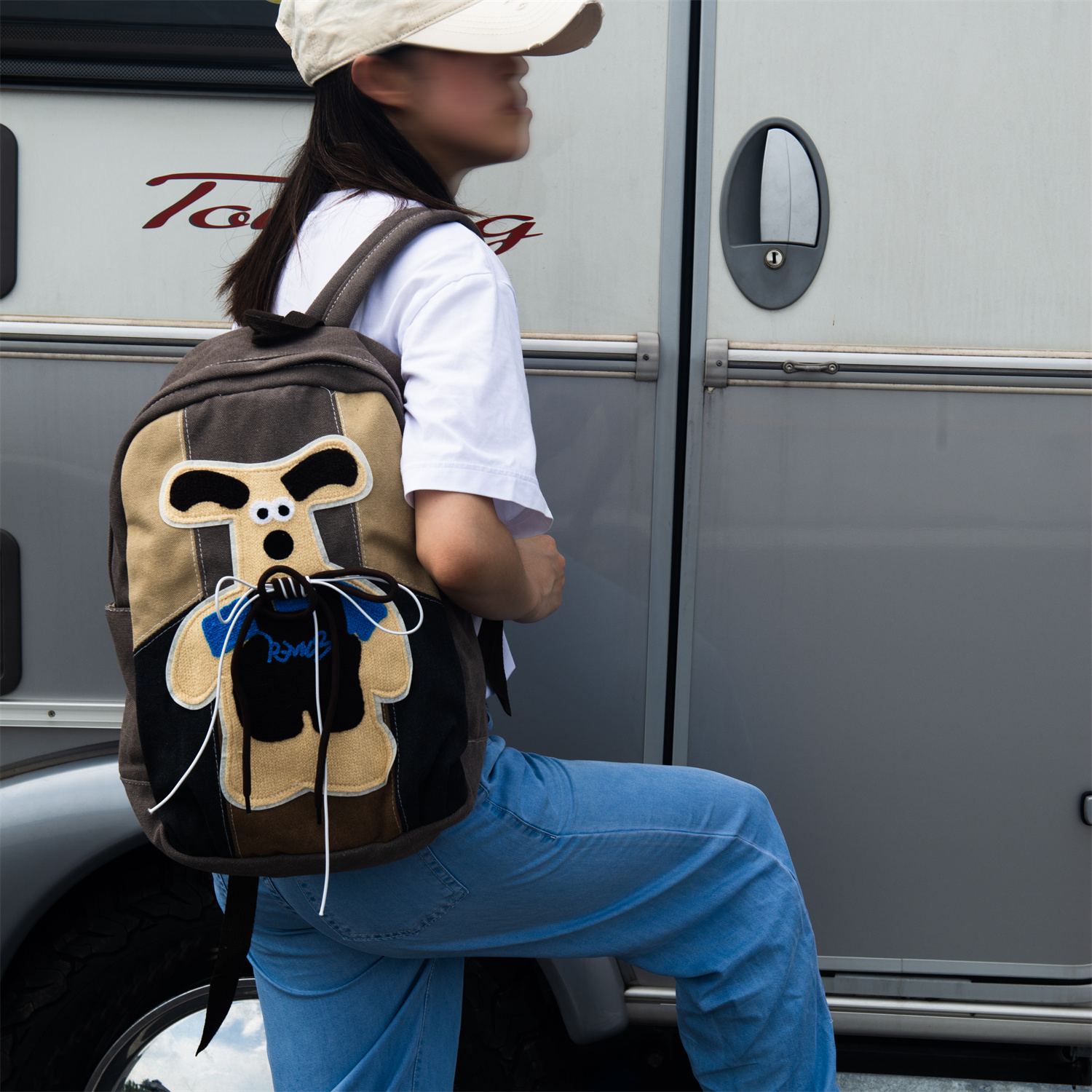 KANGA is a cute and playful backpack featuring a gray and beige colorway, a unique kangaroo print, and a secure back iPad pocket—perfect for autumn and winter fashion.