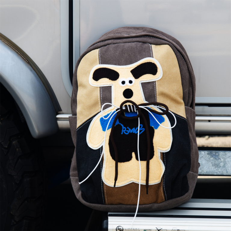KANGA is a cute and playful backpack featuring a gray and beige colorway, a unique kangaroo print, and a secure back iPad pocket—perfect for autumn and winter fashion.