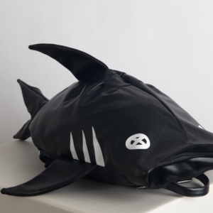 Make a bold statement with the SHARK-SAN backpack. Featuring a striking shark-inspired design and crafted from lightweight, waterproof material, this compact bag offers just enough room for your phone, wallet, and a small water bottle—perfect for casual meetups and stylish adventures.