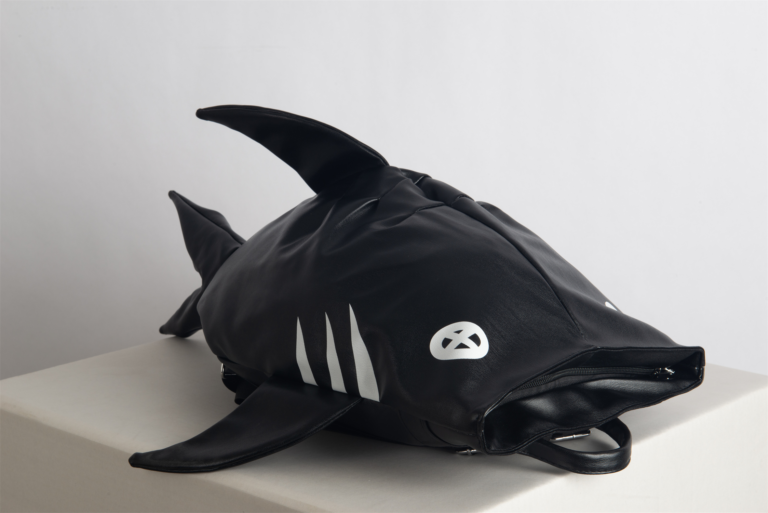 Make a bold statement with the SHARK-SAN backpack. Featuring a striking shark-inspired design and crafted from lightweight, waterproof material, this compact bag offers just enough room for your phone, wallet, and a small water bottle—perfect for casual meetups and stylish adventures.