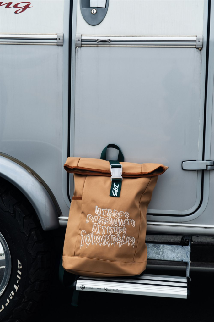 Roll-top backpack with bold design and multiple compartments for daily essentials and travel.