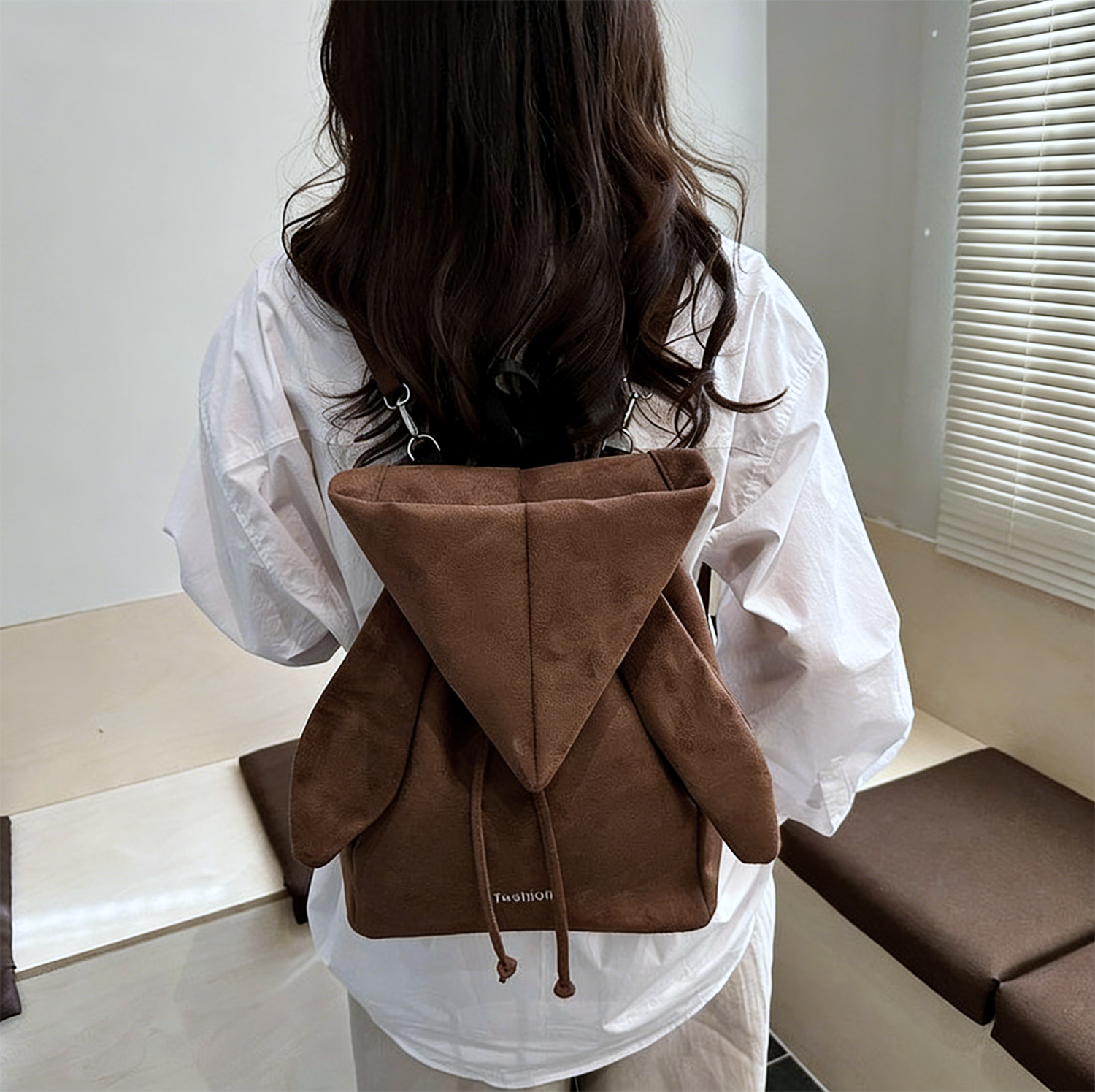 Korean style backpack brings out your Kpop idol energy. This brown backpack is lightweight and small with bunny ears design. It has a drawstring design and can be converted into a chic crossbody bag.