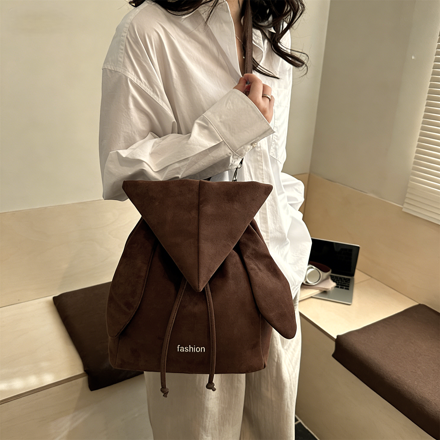 Korean style backpack brings out your Kpop idol energy. This brown backpack is lightweight and small with bunny ears design. It has a drawstring design and can be converted into a chic crossbody bag.