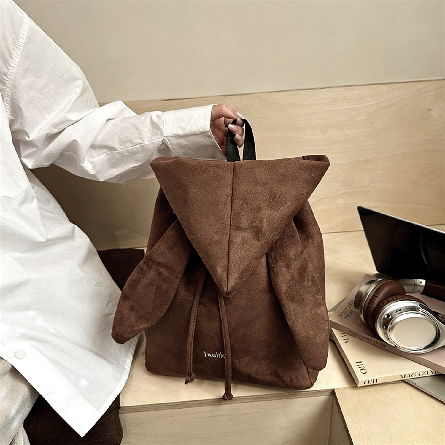 Korean style backpack brings out your Kpop idol energy. This brown backpack is lightweight and small with bunny ears design. It has a drawstring design and can be converted into a chic crossbody bag.