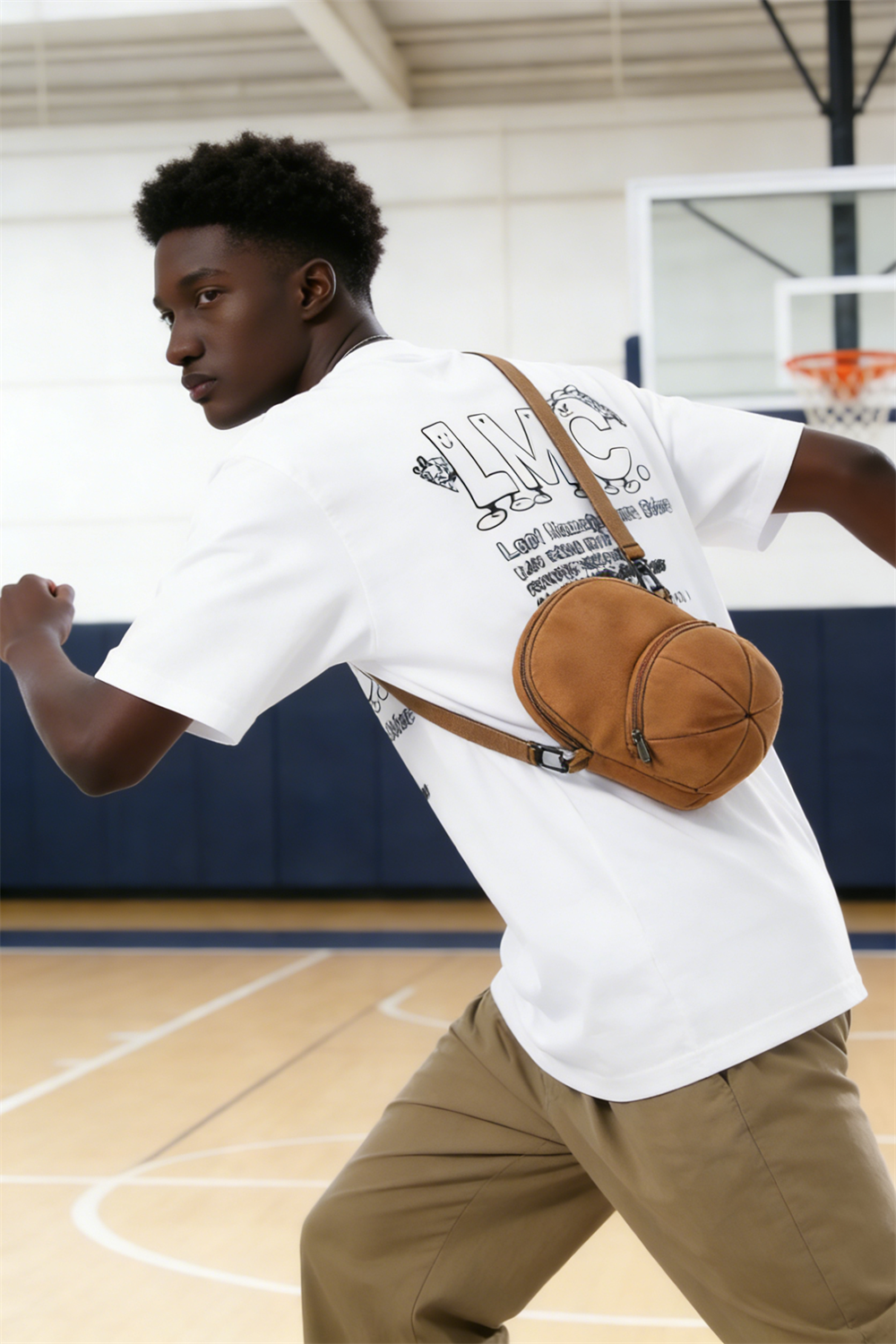 An American high schooler wearing the HATTO mustard yellow mini crossbody bag while playing basketball.