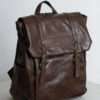 Waterproof PU leather backpack in brown, dark academia style perfect for work, school, and travel. Waterproof and wear-resistant, keeps the vintage look fresh. Backpack has many compartments, adjustable straps, and fits a 14 inch laptop.