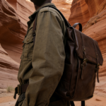 Waterproof PU leather backpack in brown, dark academia style perfect for work, school, and travel. Waterproof and wear-resistant, keeps the vintage look fresh. Backpack has many compartments, adjustable straps, and fits a 14 inch laptop.